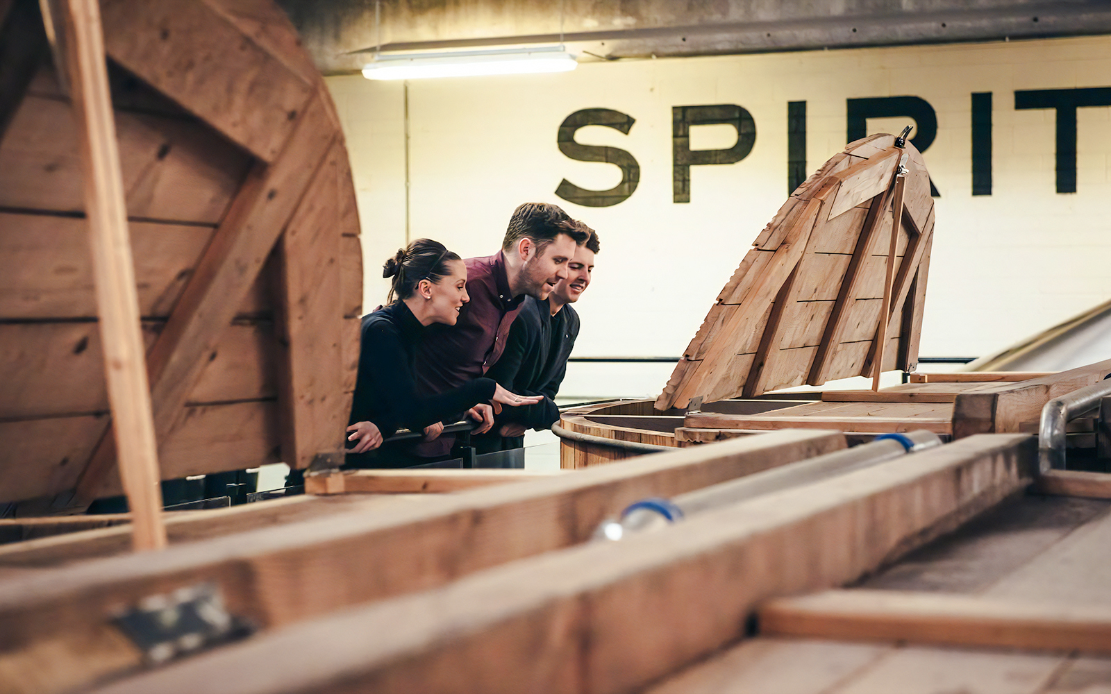 Visitors observing whiskey barrels at Teeling Whiskey Distillery.