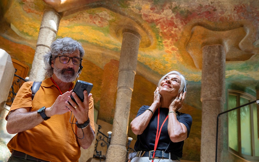 Visitors enjoying an audio tour at La Pedrera, Barcelona.