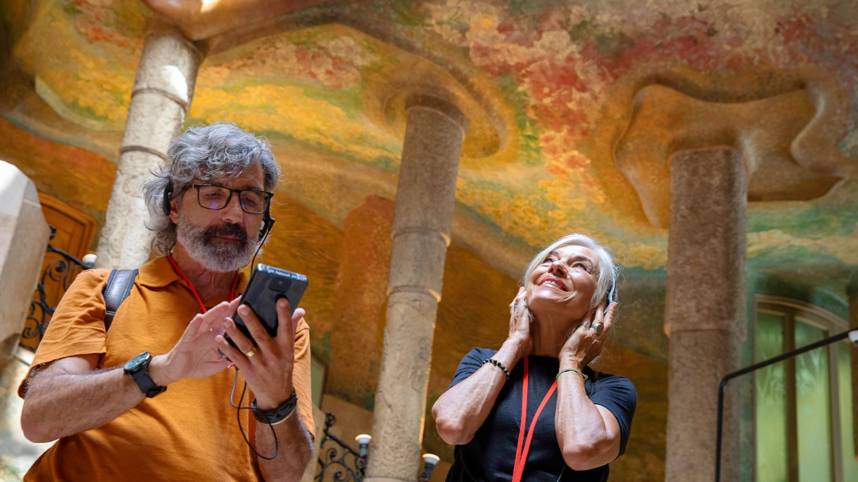 Visitors enjoying an audio tour at La Pedrera, Barcelona.