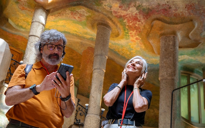 Visitors enjoying an audio tour at La Pedrera, Barcelona.