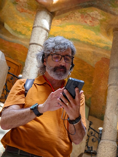 Visitors enjoying an audio tour at La Pedrera, Barcelona.