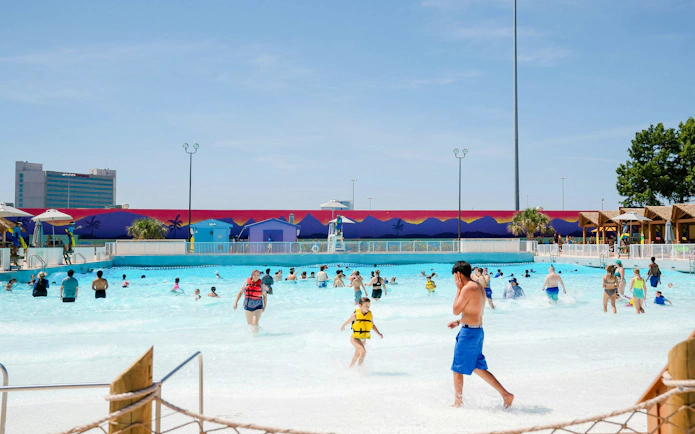 Visitors enjoying the wave pool at Surf Lagoon, Hurricane Harbor, Six Flags Arlington.