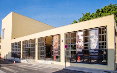 Heraklion Archaeological Museum entrance with banners displaying sculptures and frescoes.