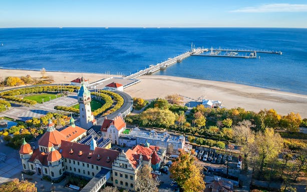 Aerial view of Sopot city with pier and beach, highlighting Gdansk airport transfers.