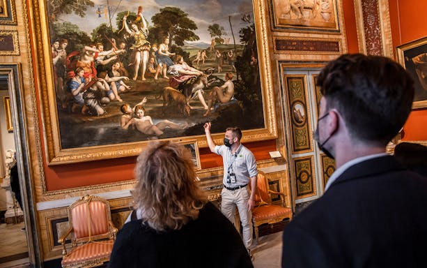 Guide explaining a painting to visitors at Borghese Gallery, Rome.
