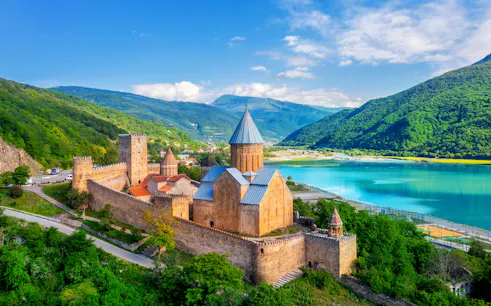 Aerial view of Ananuri Fortress Complex by a turquoise lake in Georgia.