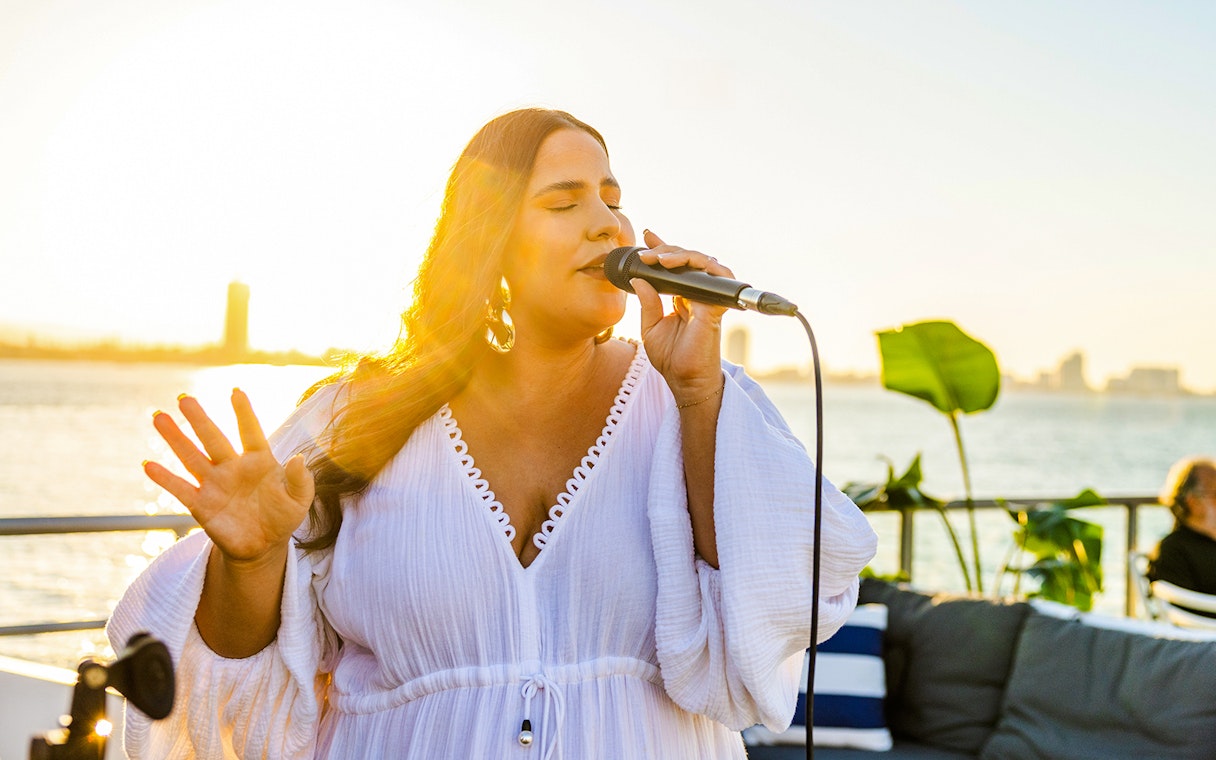 Live music performance on Gold Coast sightseeing cruise at sunset.