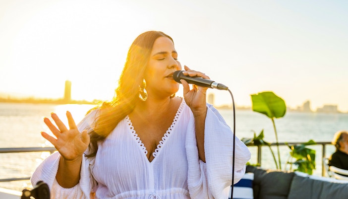Live music performance on Gold Coast sightseeing cruise at sunset.