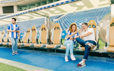 Visitors at FC Porto stadium museum exploring the team bench area.