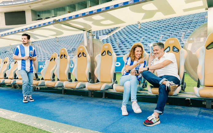 Visitors at FC Porto stadium museum exploring the team bench area.