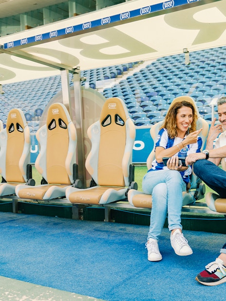 Visitors at FC Porto stadium museum exploring the team bench area.