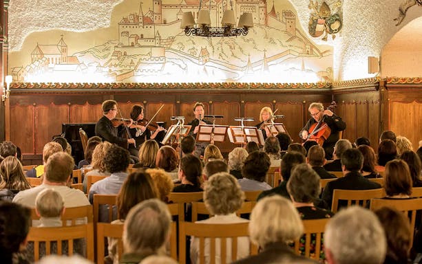 Musicians performing Mozart at Fortress Hohensalzburg concert hall in Salzburg, Austria.