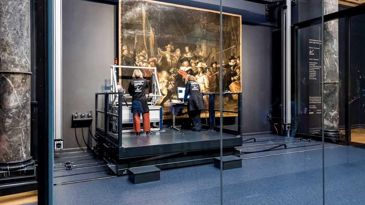 Conservators analyzing Rembrandt's Night Watch at Rijksmuseum, Amsterdam.