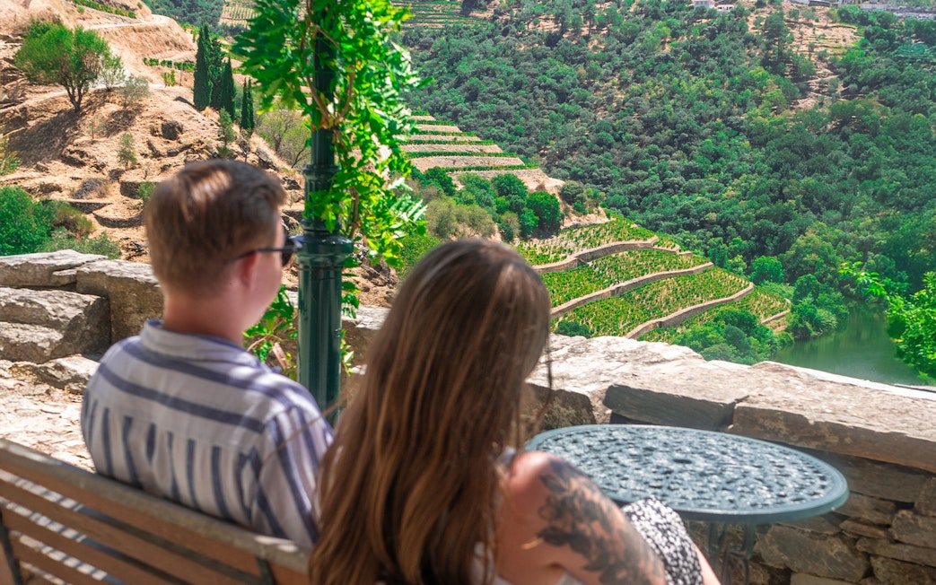 Tourists admiring terraced vineyards in Douro Valley, Portugal.