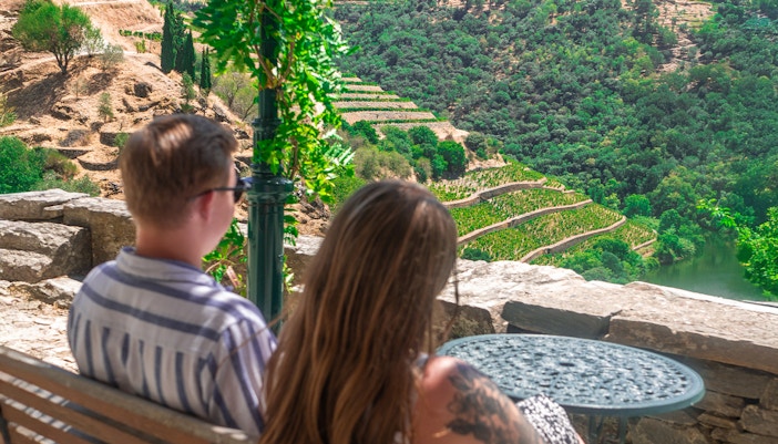 Tourists admiring terraced vineyards in Douro Valley, Portugal.