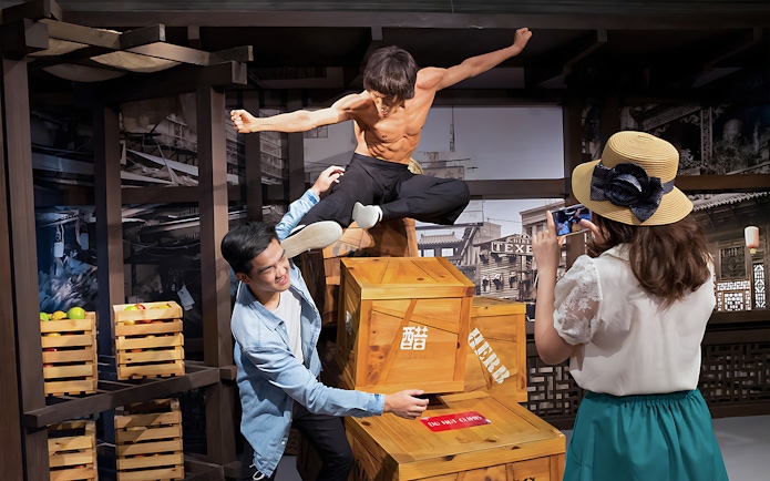 Tourists with Bruce Lee statue at Madame Tussauds, Singapore.