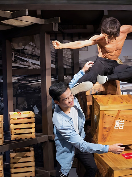 Tourists with Bruce Lee statue at Madame Tussauds, Singapore.