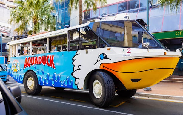 Aquaduck amphibious vehicle parked on a city street, part of the Combo: Aquaduck Tour and Paradise Jet Boating.