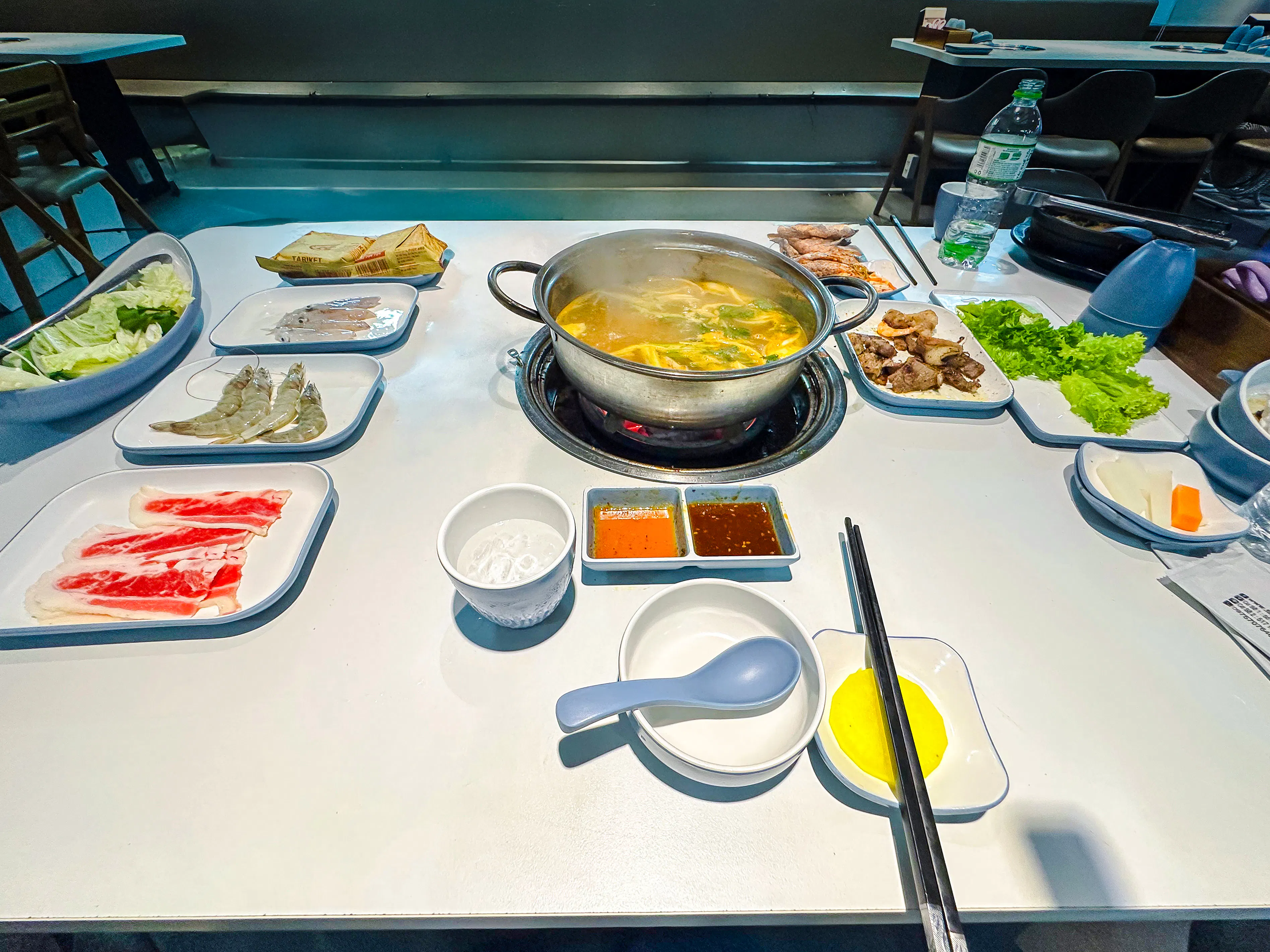 Hot pot dinner setup with seafood, vegetables, and sauces on Phu Quoc Sunset Tour.