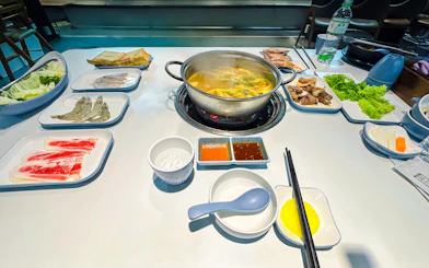 Hot pot dinner setup with seafood, vegetables, and sauces on Phu Quoc Sunset Tour.