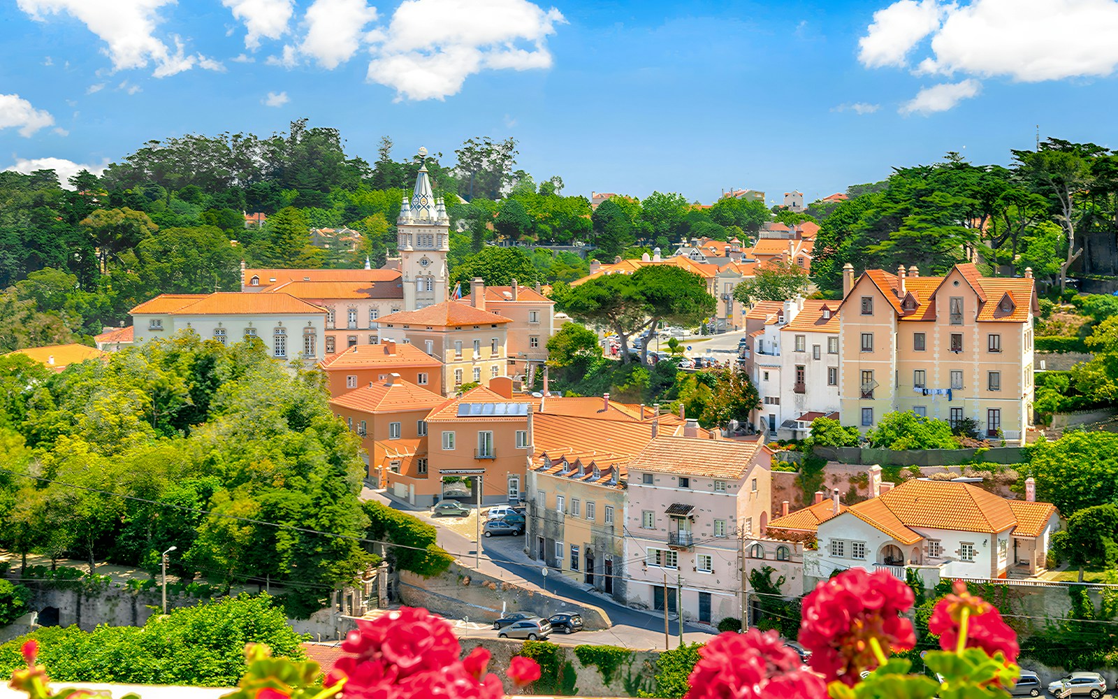 Pena Palace in Sintra with colorful turrets and lush forest surroundings.