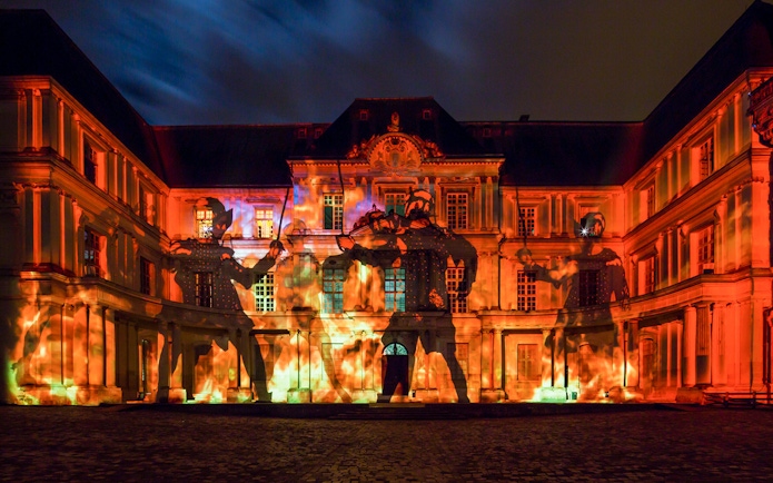 Sound and Light Show at Royal Château of Blois with illuminated facade and projected figures.