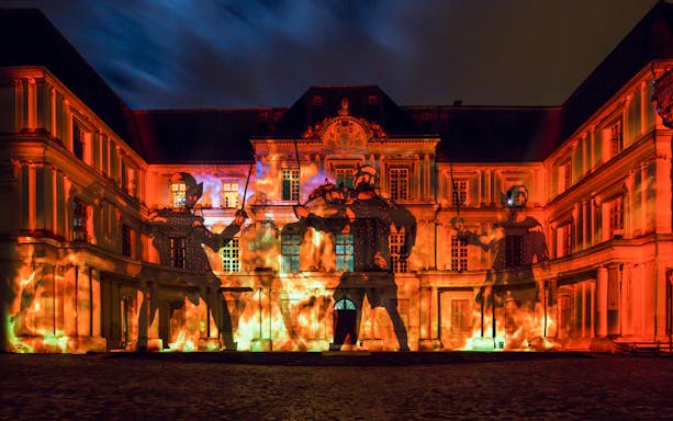 Sound and Light Show at Royal Château of Blois with illuminated facade and projected figures.