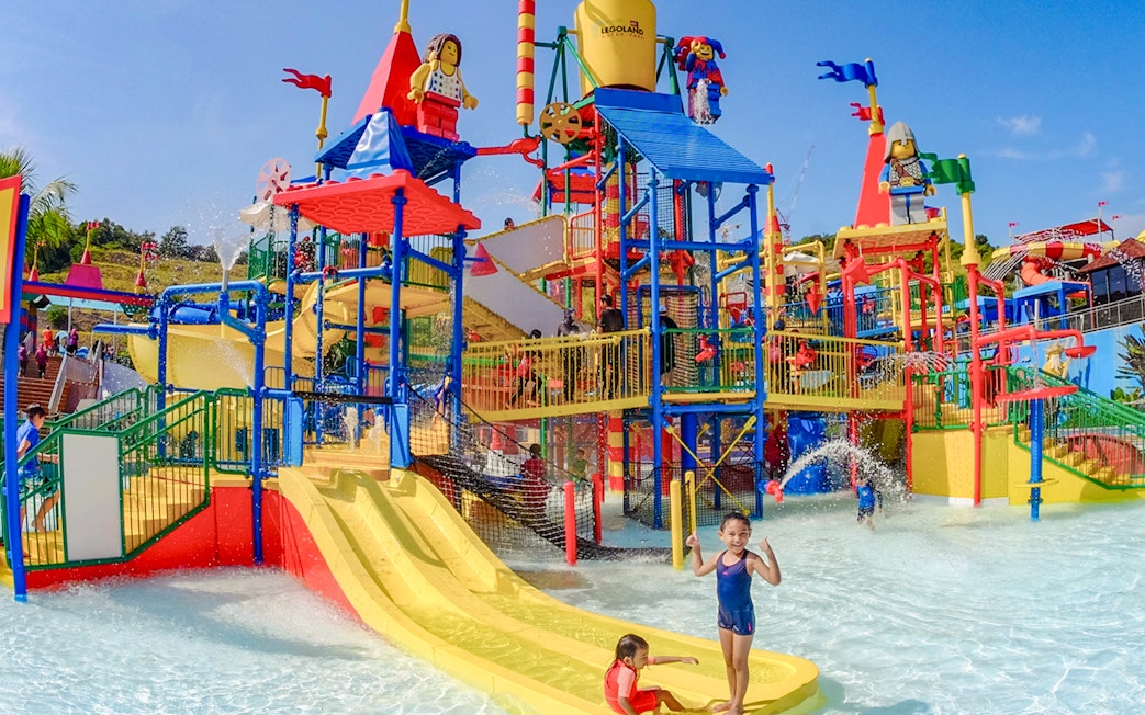 Children playing on colorful water slides at Legoland water park in Gardaland, Verona.