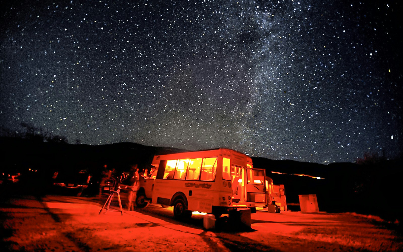 Mauna Kea Observatory tour bus under starry night sky.