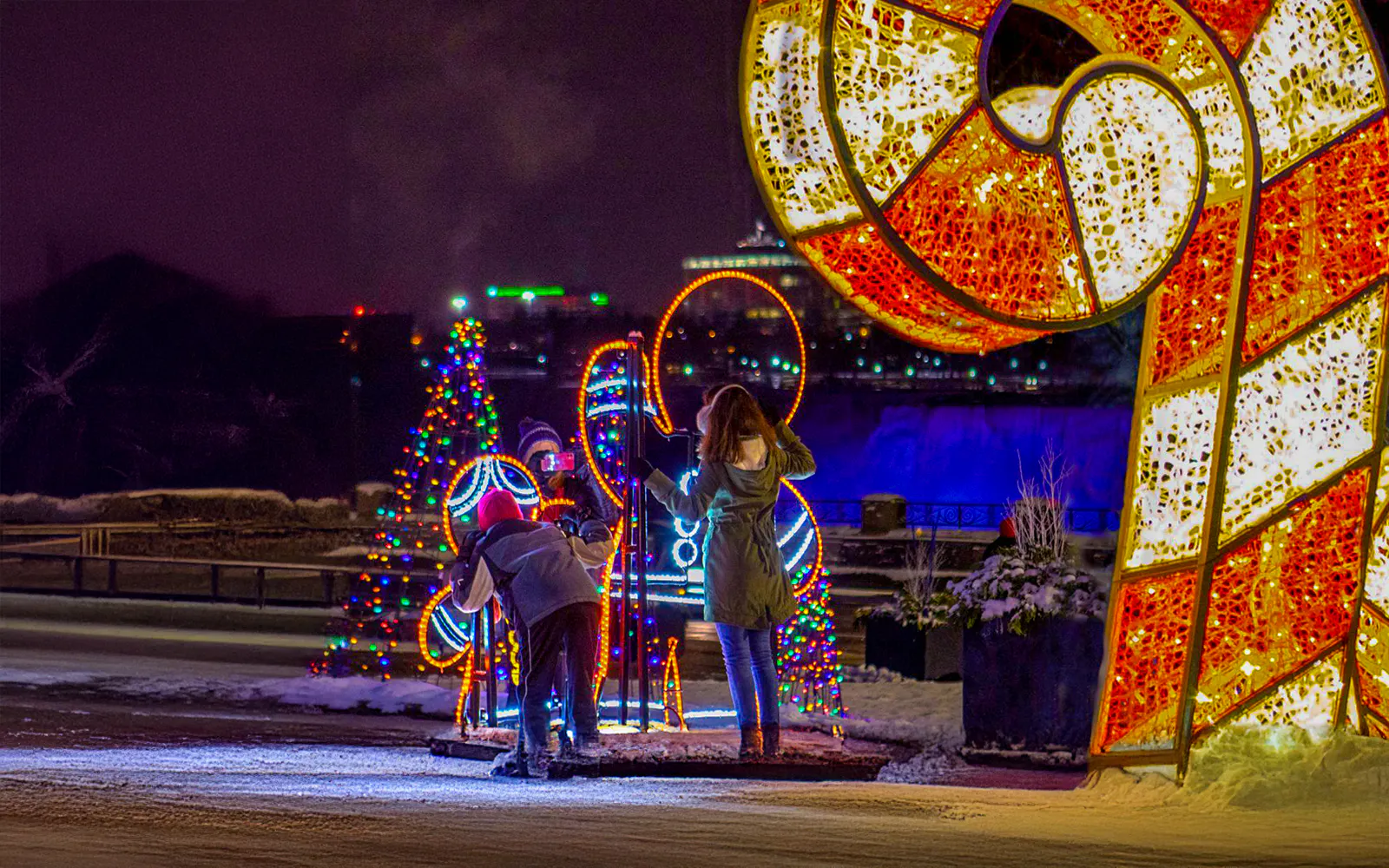 Visitors admire illuminated displays at Niagara Festival of Lights Tour.