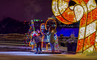 Visitors admire illuminated displays at Niagara Festival of Lights Tour.