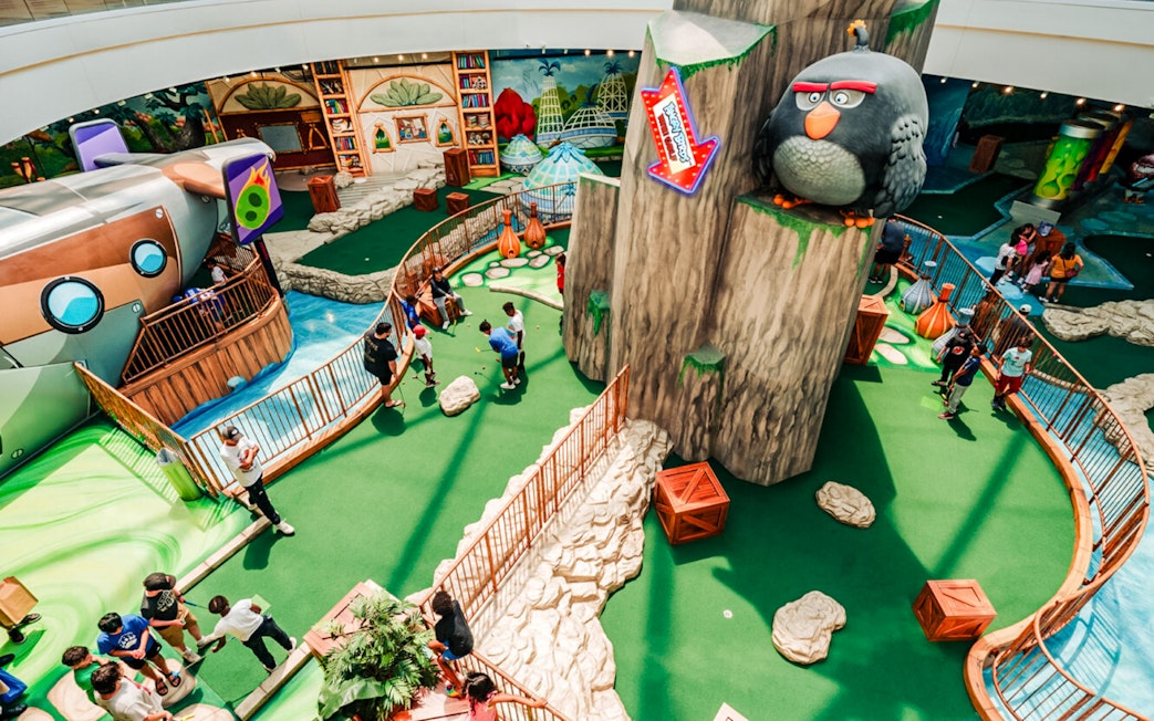 Mini golf course at Angry Birds American Dream with themed obstacles and players.