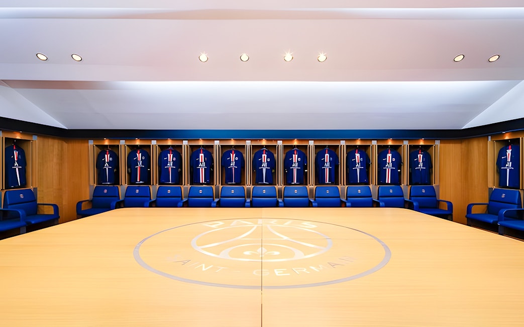 PSG Stadium locker room with team jerseys on display, Paris, France.