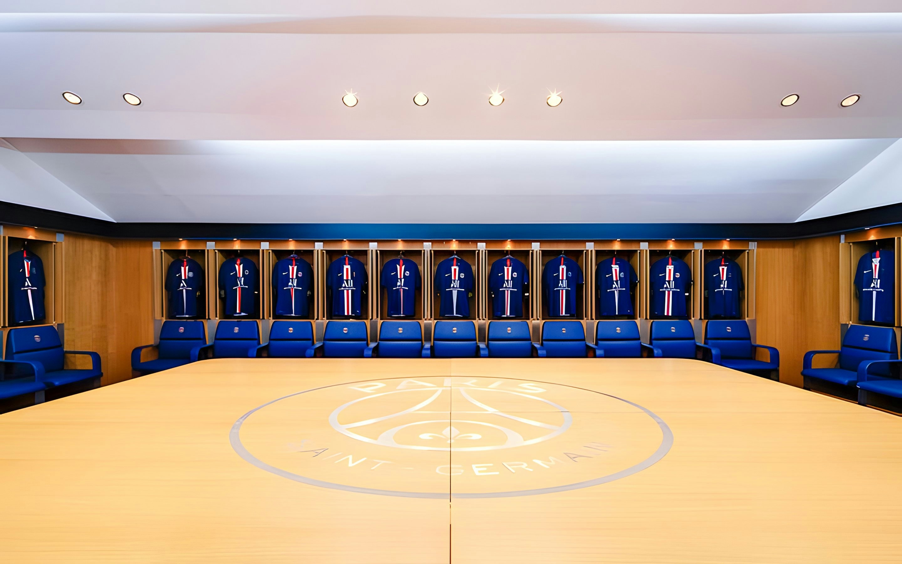 PSG Stadium locker room with team jerseys on display, Paris, France.