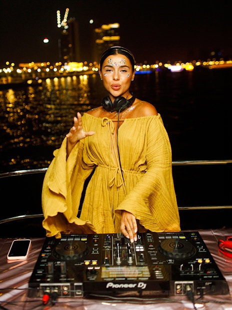 DJ performing on a yacht at night during Dubai Sunset Yacht Tour.