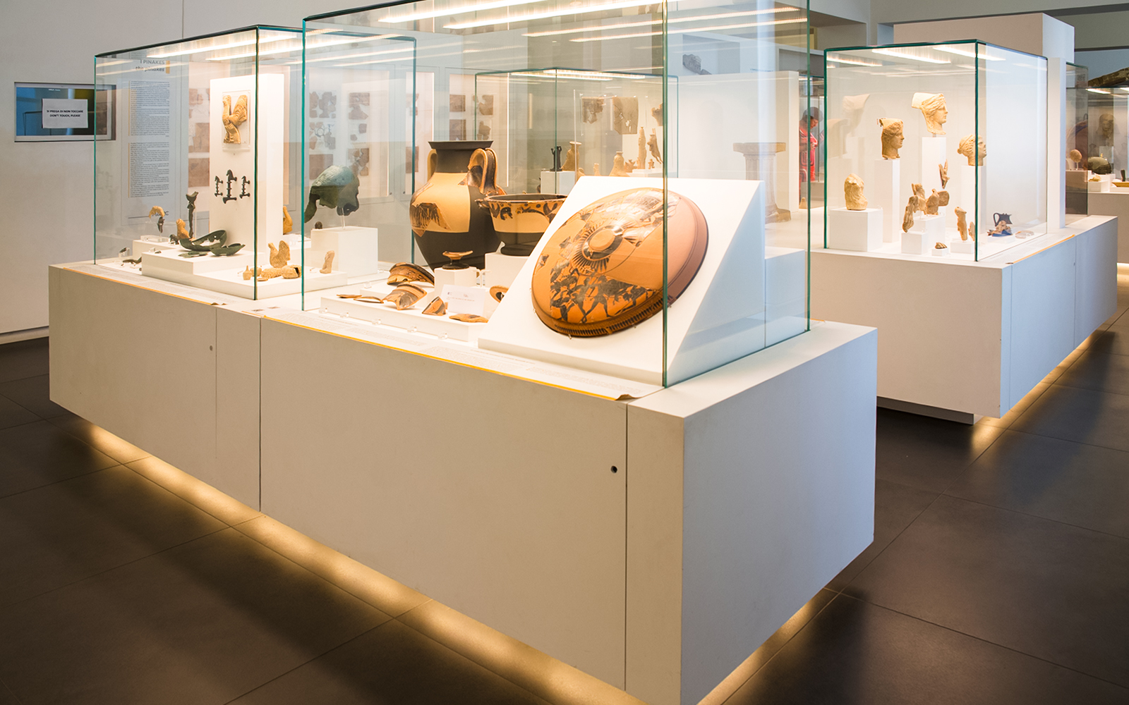 Ancient artifacts displayed in a modern museum exhibit.