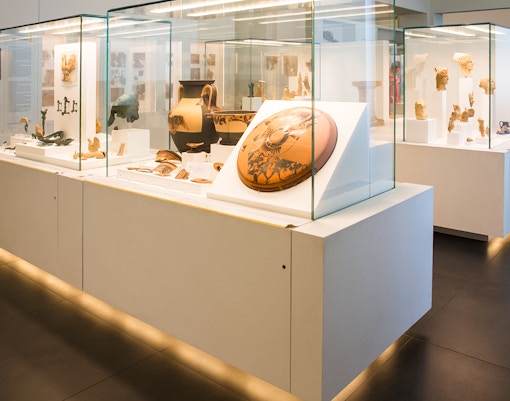 Ancient artifacts displayed in a modern museum exhibit.