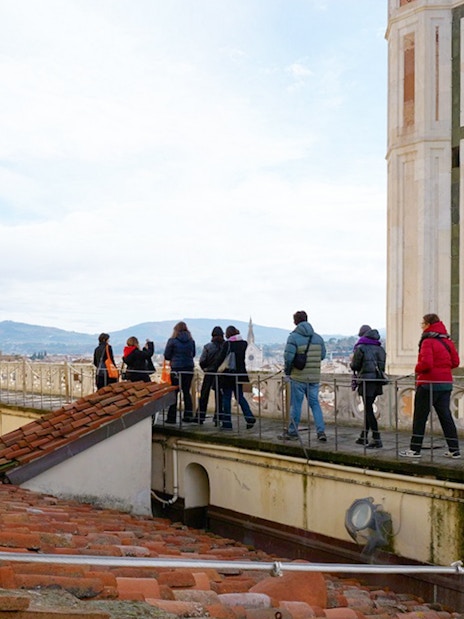 Visitors with a guide on the terrace of Florence Cathedral, Italy.