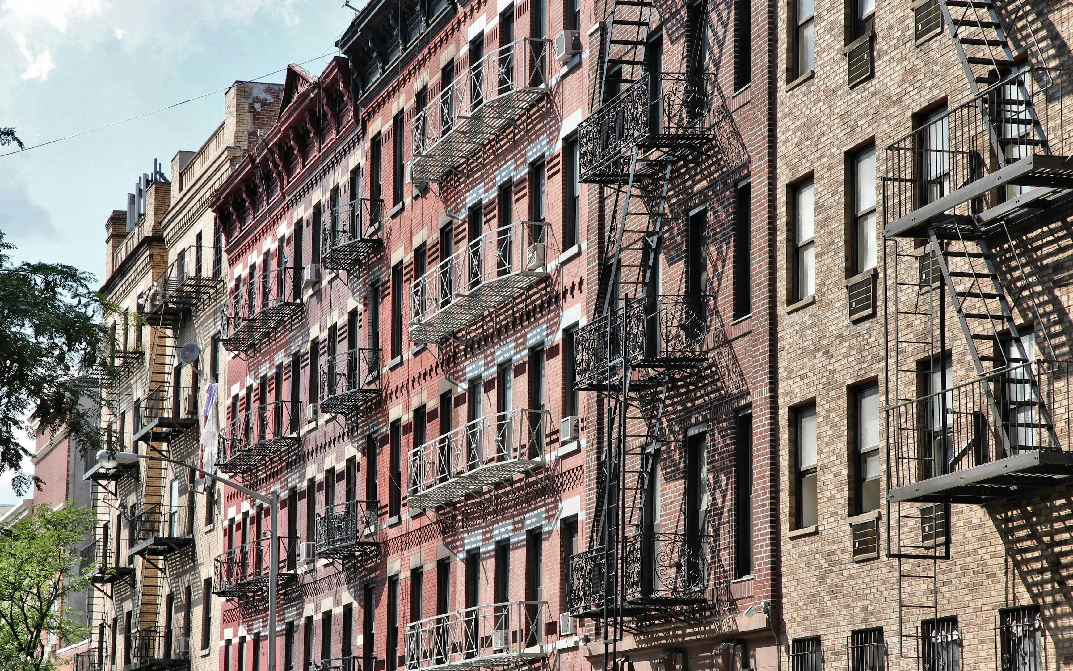Historic brick buildings with fire escapes in SoHo, New York City.