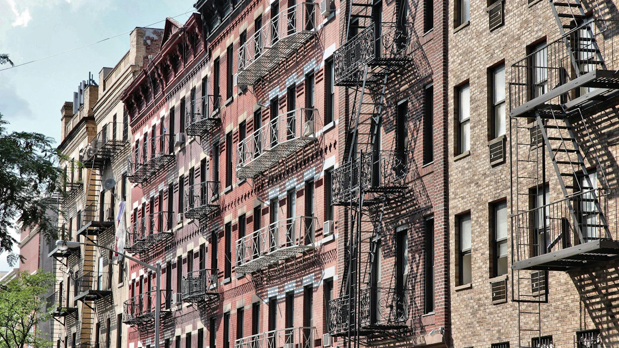 Historic brick buildings with fire escapes in SoHo, New York City.