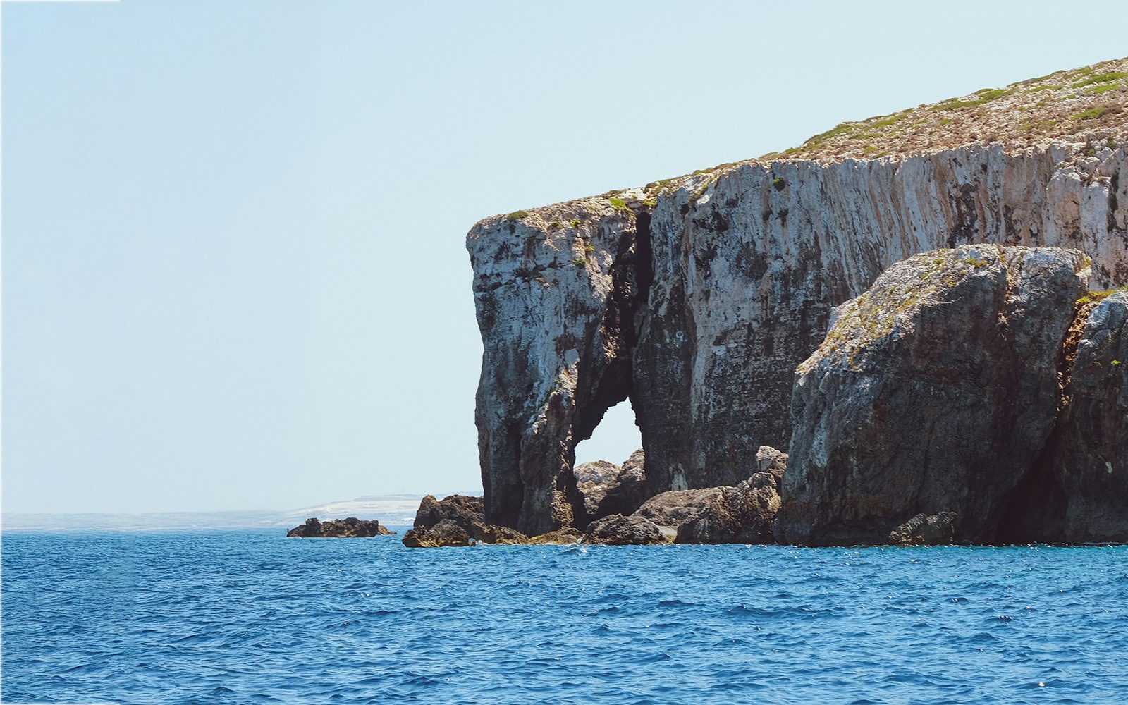 Elephant Rock formation in the Mediterranean Sea, Malta, with clear blue waters.