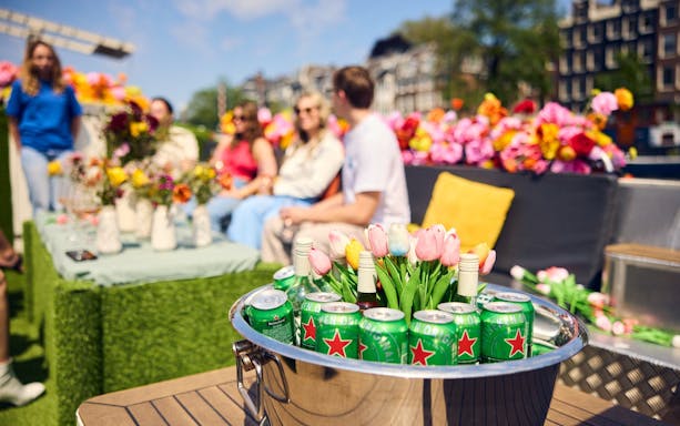Luxury flower boat with drinks and tulips, people enjoying City Highlights Cruise.