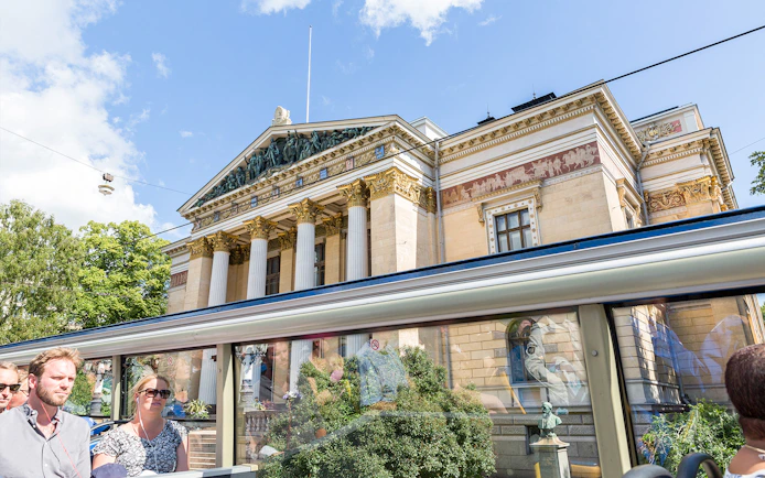 Helsinki Hop-On Hop-Off bus passing by the Finnish National Theatre.