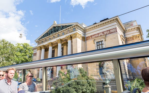 Helsinki Hop-On Hop-Off bus passing by the Finnish National Theatre.