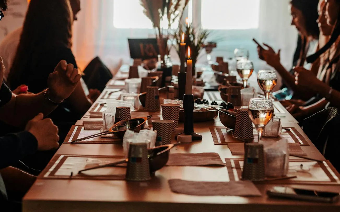 Candle-making workshop setup with wine glasses and materials in Krakow studio.