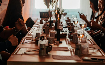 Candle-making workshop setup with wine glasses and materials in Krakow studio.
