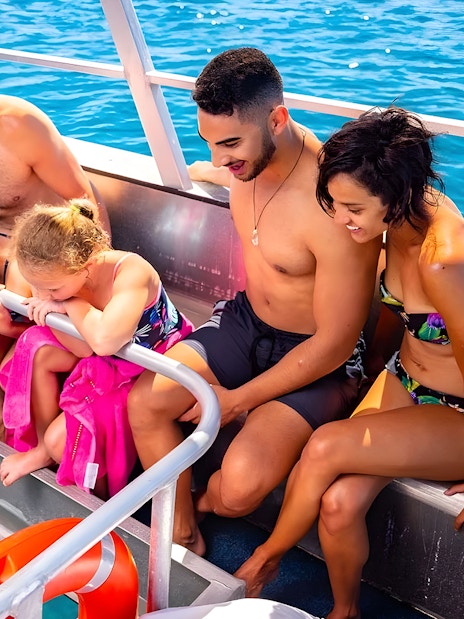 Tourists on a glass-bottom boat viewing Moore Reef, Great Barrier Reef.