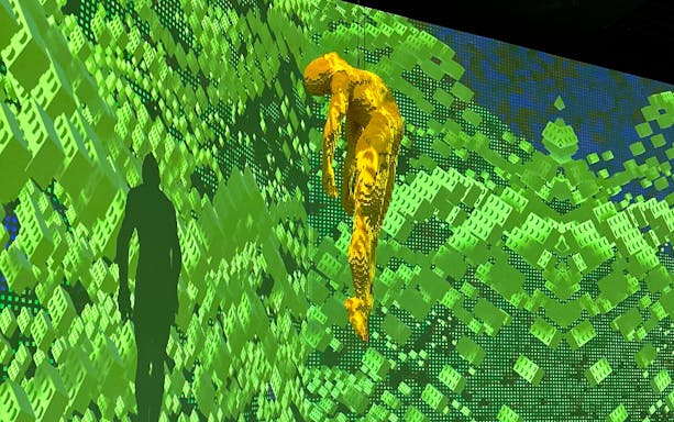 Yellow LEGO figure suspended in front of green digital background at Australia: The Art of the Brick.