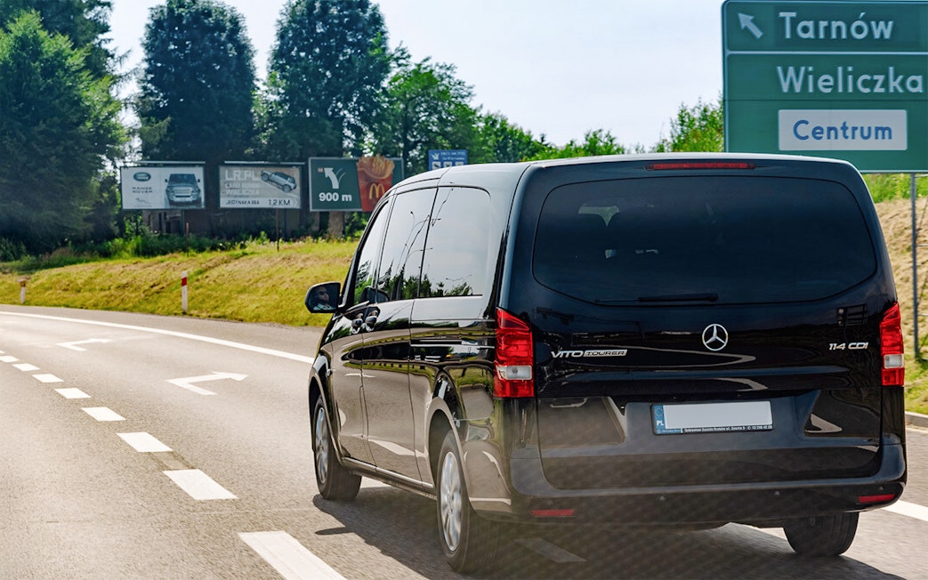 Van traveling on road towards Wieliczka Salt Mine, Poland.