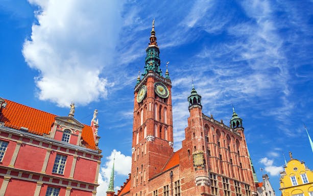 Gdansk Town Hall tower under a blue sky, seen from Gdansk city center.